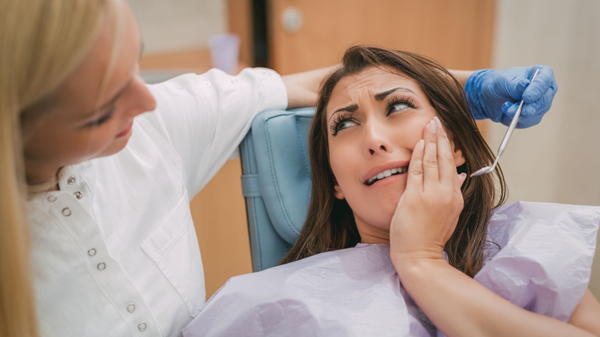 - Anxious woman at the dentist during dental exam in Edmonton.